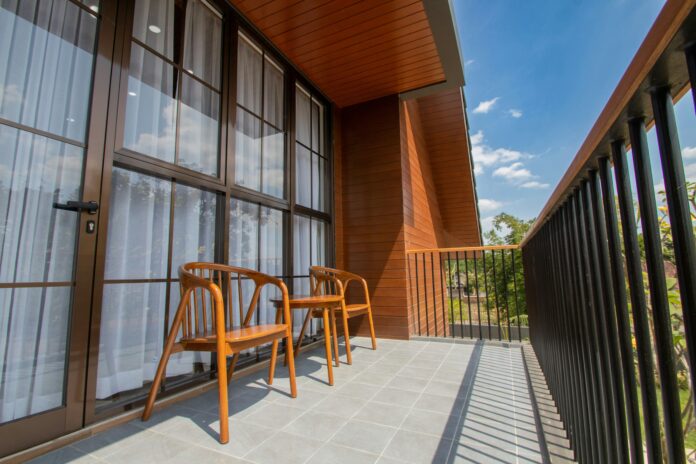 Outdoor apartment balcony with two chairs.